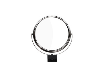 Desktop make up cosmetic mirror isolated on white back. Round turning small mirror in a metal frame.
