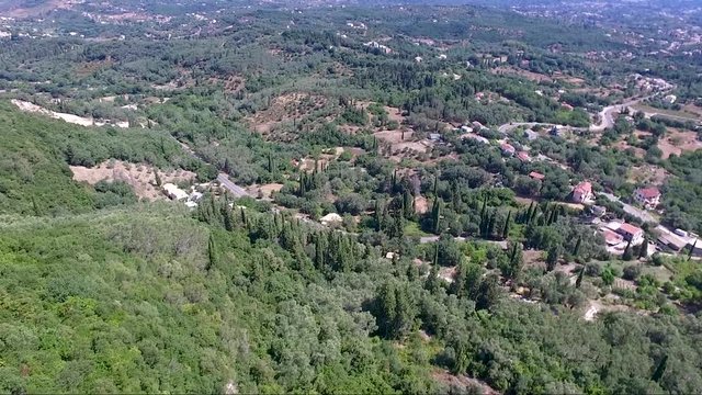 Aerial view of hill with trees and after plain in area of kaiser's throne in Greek island of Corfu, move forward by drone