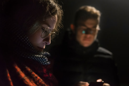 Close-up of a white woman using a phone with his friend