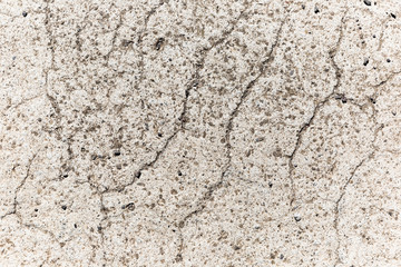 Eroding & cracking white concrete surface.
