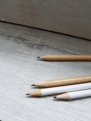 Obraz premium graphite pencil on wooden white background