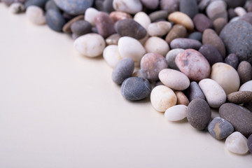 Fototapeta na wymiar Varied pebbles on white background angle view