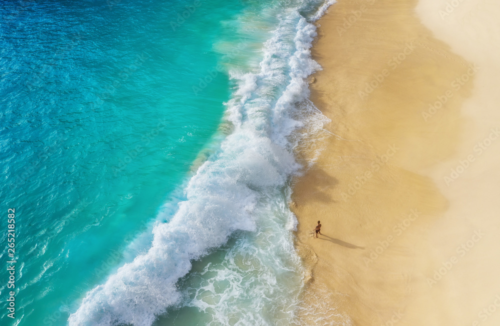 Wall mural beach as a background from top view. waves and azure water as a background. summer seascape from air