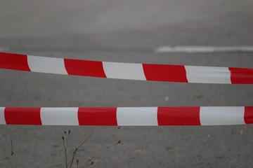 Barrier tape closes a street because of accident or construction site or crime scene