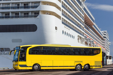 YELLOW BUS - Tourist vehicle in the sea port with a cruise ship in the background