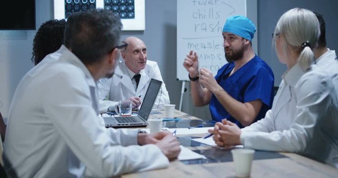 Doctor making his colleagues laugh with story