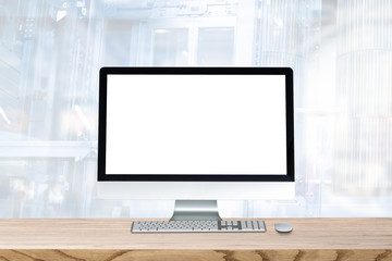 Blank screen desktop computer on plank wooden table top with blur background. Office interior with blurry background.