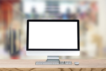 Blank screen desktop computer on plank wooden table top with blur background. Office interior with...