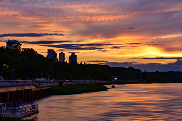 Fototapeta premium View of a golden sunset sky with clouds from the river shore