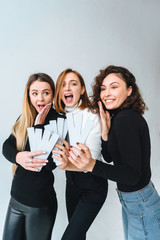 Three beautiful young girls posing for the camera