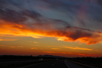 Fototapeta na wymiar Colorful cloudy evening sky illuminates the newly constructed highway in Croatia