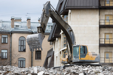 Building of the former hotel demolition for new construction, using a special hydraulic...