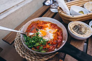 Shakshuka, Fried Eggs in Tomato Sauce on the Table