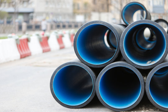 Overhaul Of PVC Water Pipes In The City, Front View, Blurred Background. Water Supply Concept. Repair Of Utilities