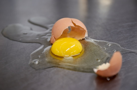 Broken chicken egg on the iron table close-up. horizontal view. a raw egg.