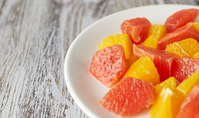 Orange-grapefruit citrus salad on a shabby wooden table. copy space. summer vitamin salad.