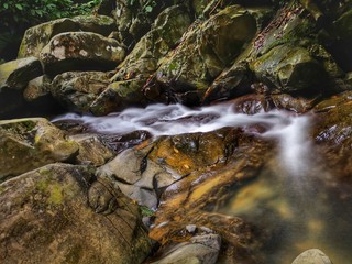 Beautiful silky smooth waterfall stream in the jungle of rainforest Sabah, Borneo.