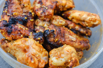 Grilled chicken wings in plate.