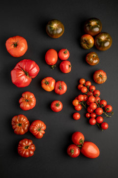 from above view of tomatoes on a black surface