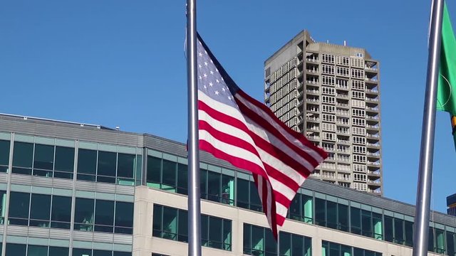 American Flag on a flagpost moved by wind in the air.