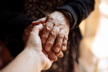 Grandson holding his grandmother's hand