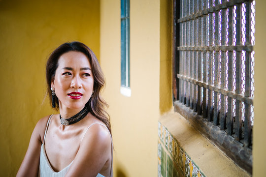 Young trendy chinese woman enjoying holidays at a luxurious resort