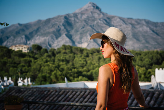 Young classy chinese woman in panama hat and sunglasses enjoying a bright summer day