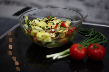 Close-up of vegan salad on black table.