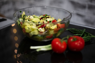 Close-up of vegan salad on black table.
