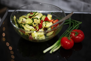 Close-up of vegan salad on black table.
