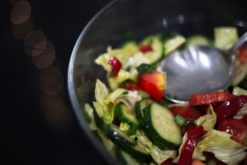 Close-up of vegan salad on black table.