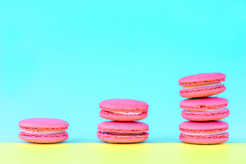 Pink macaroons on a yellow background. Concepts of classification and growth