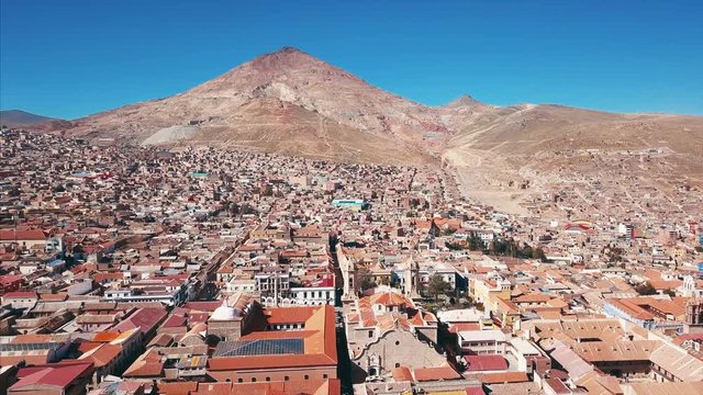 Flight over the city of Potosi with the mountain of Cerro Rico (which has the world's largest silver deposit) on the background, Bolivia
