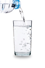 Pouring water into glass isolated on white