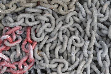 Grey and blood red steal chains at a shipyard
