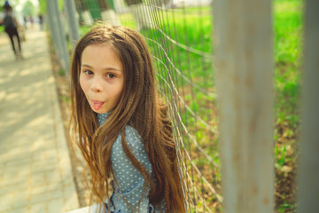 Pleased girl in casual outfit looking. Teen girl posing in the Park