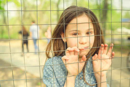 Beautiful Girl, Behind The Fence Locked In A Cage.