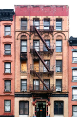 Old condemned building with boarded windows in the Lower East Side neighborhood of Manhattan in New York City