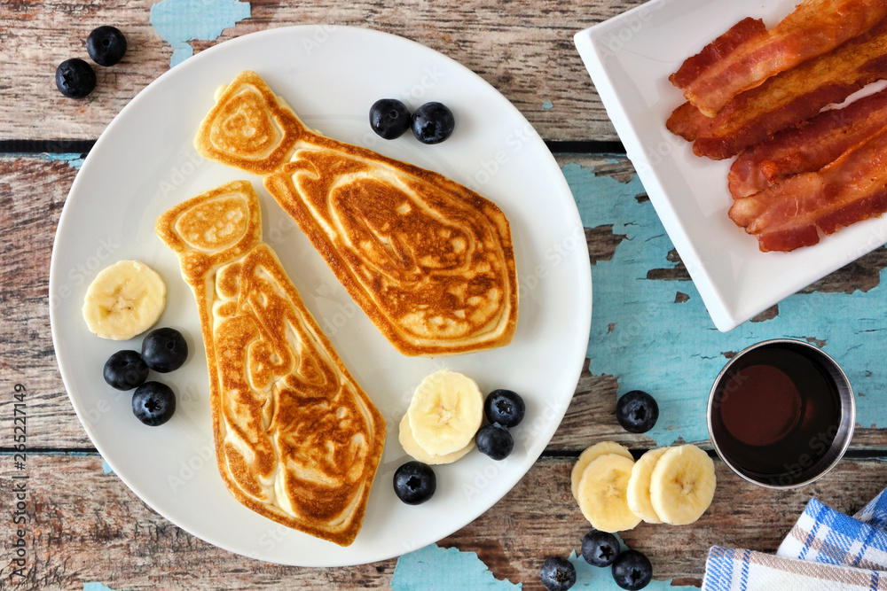 Poster tie shaped pancakes with blueberries and bananas. fathers day breakfast concept. top view table scen