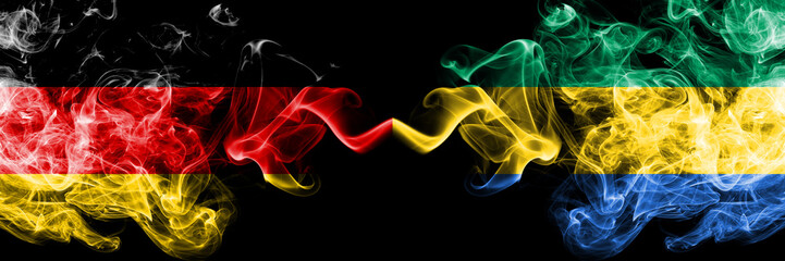 Germany vs Gabon, Gabonese smoky mystic flags placed side by side. Thick colored silky smoke flags...