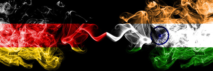 Germany vs India, Indian smoky mystic flags placed side by side. Thick colored silky smoke flags of Deutschland and India, Indian