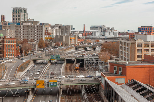 Looking down a freeway and subway tracks in urban Boston
