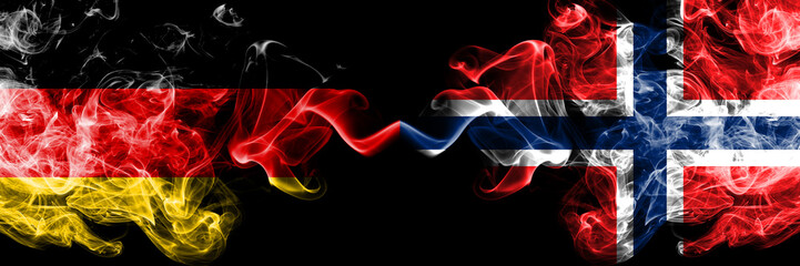 Germany vs Norway, Norwegian smoky mystic flags placed side by side. Thick colored silky smoke flags of Deutschland and Norway, Norwegian