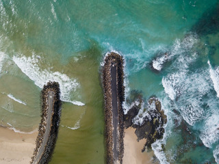 The mouth of a river entering the ocean and the two waters are mixing together