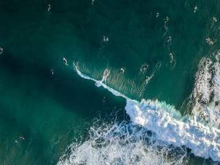 surfers in the water waiting for waves. The water is amazingly beautiful. 