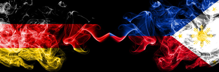 Germany vs Philippines, Filipino smoky mystic flags placed side by side. Thick colored silky smoke flags of Deutschland and Philippines, Filipino