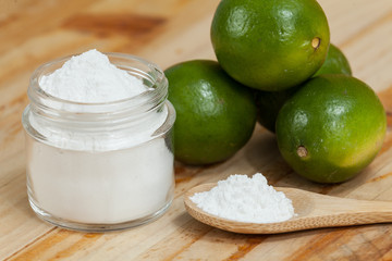 baking soda - sodium bicarbonate and lemon, on wooden background