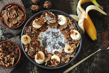 Stylish and healthy breakfast bowl. Flat Lay. Healthy breakfast with yogurt, chia seeds, cereal, banana.