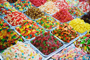Close up view of assorted colorful jelly gummy candies on outdoors market.