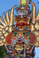 Bade cremation tower with traditional balinese sculptures of demons and flowers on central street in Ubud, Island Bali, Indonesia . Prepared for an upcoming cremation ceremony
